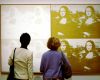 visitors-in-front-of-andy-warhols-four-white-on-white-mona-lisas_four-gold-on-white-mona-lisas-1980_acrylic-and-silkscreen-on-canvas